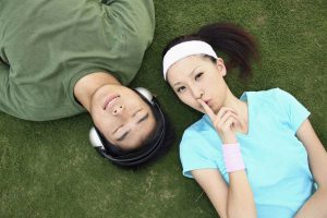 girl and guy with headphones relaxing